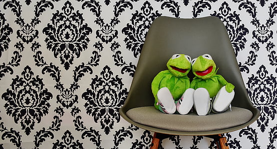 two Kermit the frog plush toys on black sofa chair thumbnail