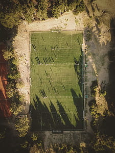 green sports field at daytime in aerial photography thumbnail