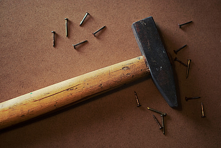 mallet and nails on brown surface thumbnail