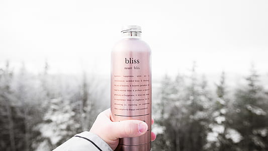 person holding Bliss labeled bottle thumbnail