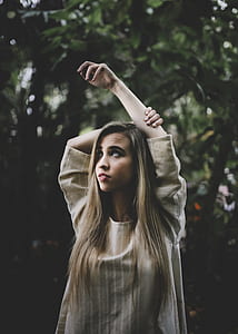 standing woman near trees during day thumbnail