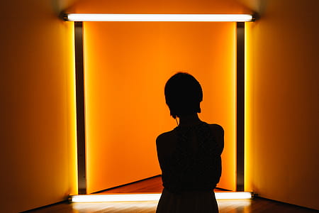 woman standing in front of yellow lamp thumbnail