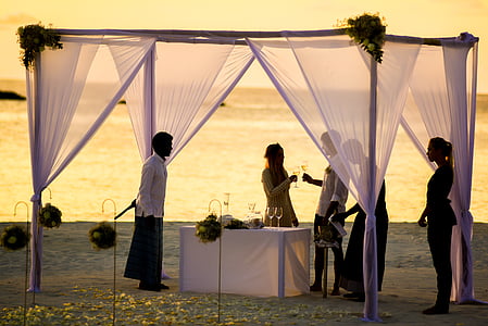 people under white canopy outdoors during golden hour thumbnail