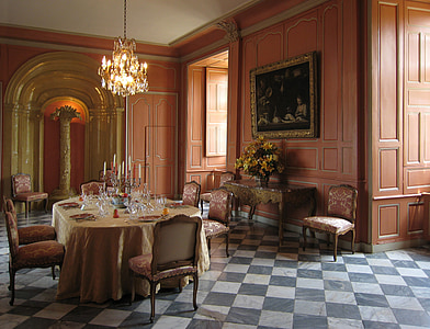 oblong brown dining table with char set under chandelier thumbnail