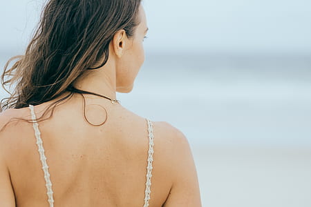 woman stand near ocean during daytime thumbnail