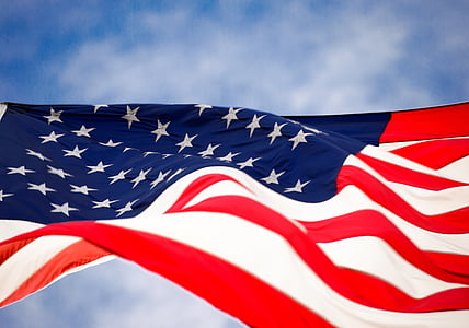 low-angle of U.S flag under cloudy sky thumbnail