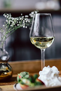 Strawberries with cream and glass of white wine on wooden tray thumbnail