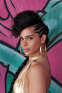 woman wearing gold-colored hoop earrings thumbnail