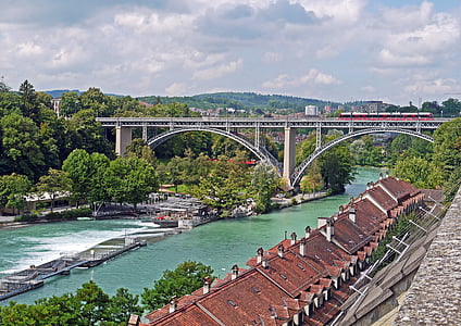 red train on steel bridge thumbnail