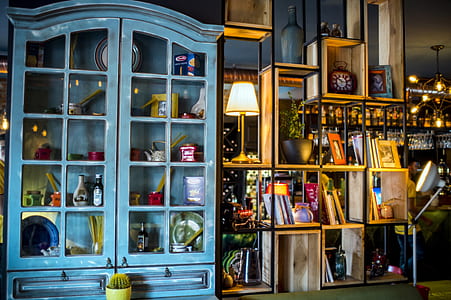 assorted decors in teal wooden display cabinet thumbnail