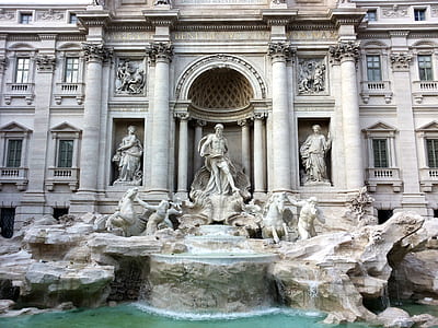 photo of gray structure with statues and body of water thumbnail