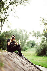 man holding black DSLR camera thumbnail