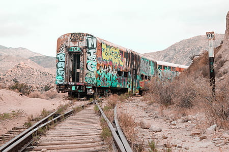 photo of multicolored train on train tracks during daytime thumbnail