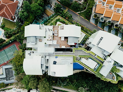 aerial photography of white concrete building near road thumbnail