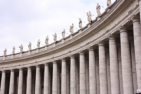 white concrete post with statue coliseum thumbnail
