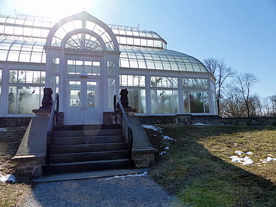 Sun shine from behind the orchid greenhouse in winter at Duke Farms New Jersey. thumbnail
