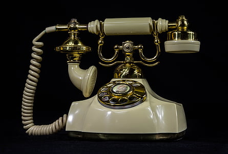 photo of white and brass rotary phone thumbnail