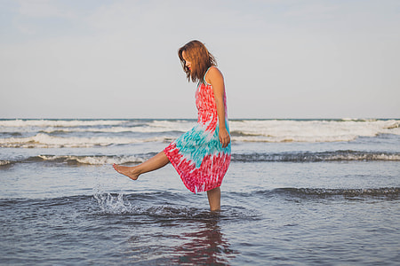 woman walking on body of water during daytime thumbnail