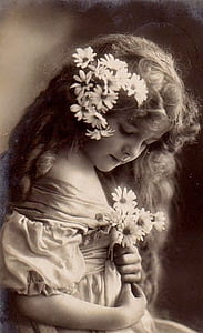 grayscale photography of girl holding flowers thumbnail