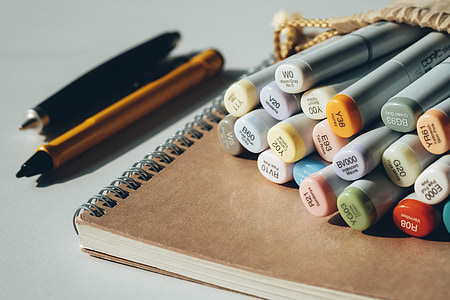 focus photography of coloring pen with notebook thumbnail