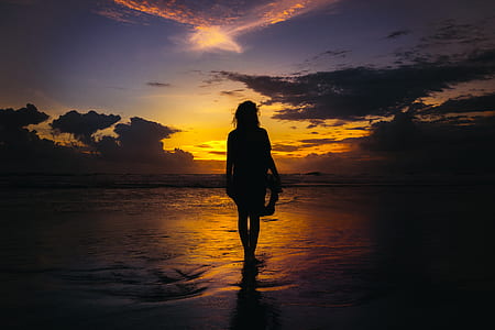 photo of woman near seashore near golden hour thumbnail