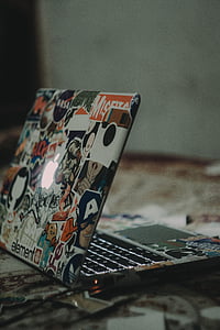 gray laptop with stickers thumbnail