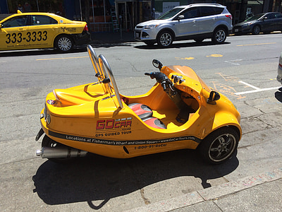 yellow battery-powered ride-on car on road thumbnail