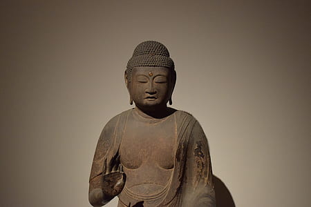 Buddha statue against white background thumbnail