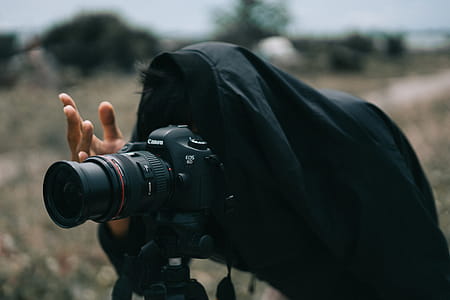 Person in Black Jacket Facing Black Canon Dslr Camera thumbnail