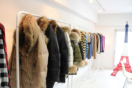 several parka jackets on rack inside room thumbnail