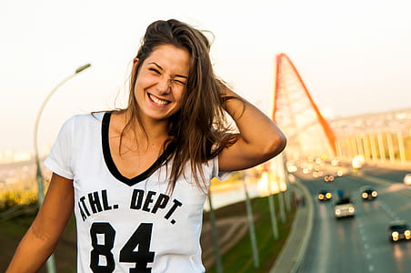 woman standing near bridge making face thumbnail