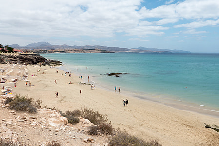 people walking on white sanded beach during daytime thumbnail