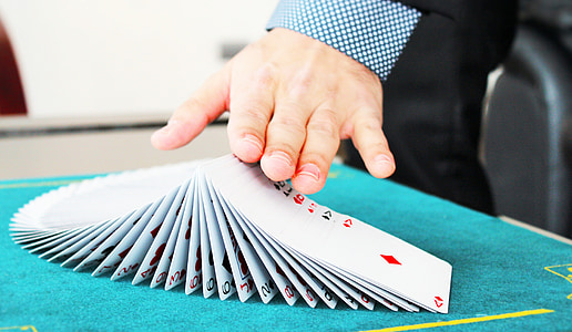 person hands on top of playing cards thumbnail