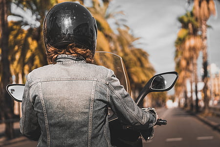 woman wearing gray denim jacket riding on black motor scooter thumbnail