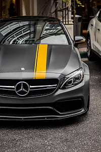 closeup photo of parked matte gray Mercedes-Benz C63 AMG during daytime thumbnail