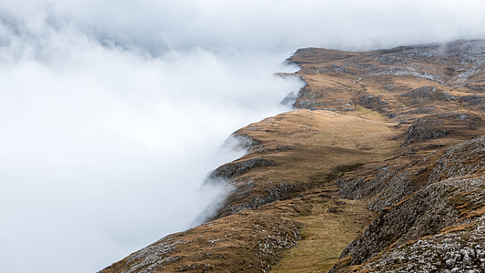 brown mountain covered with white clouds thumbnail