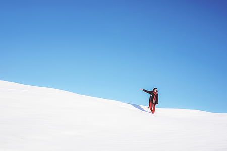 woman standing on snow field thumbnail