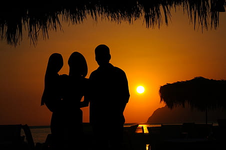 Family silhouette against sunset backdrop. thumbnail