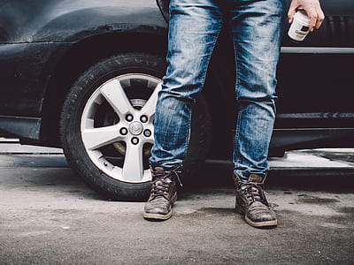 person wearing black leather boots and denim jeans thumbnail
