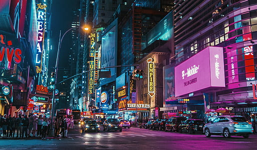 cars and people on street at night time thumbnail