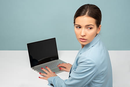 Woman Holding Laptop Computer While Facing Backward thumbnail