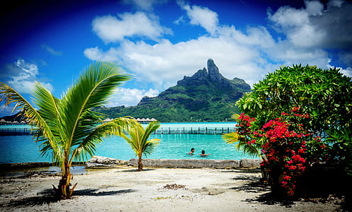 view of beach with mountains on other side of shoree thumbnail