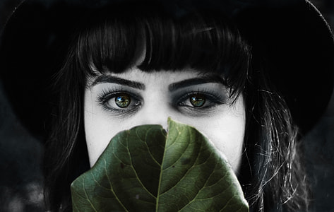 selective color photography of woman behind green leaf thumbnail