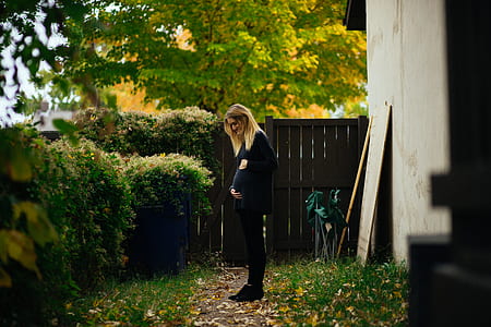 woman standing beside house thumbnail