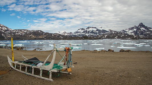 sled on soil beside water thumbnail