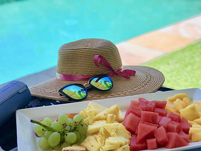 slice fruits on white tray beside hat thumbnail