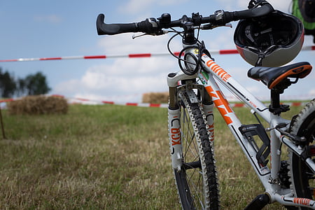 close-up photography of white KTM full suspension bike on green grass field thumbnail