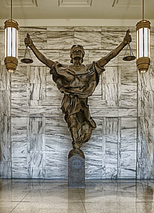 Justice Statue inside hall at daytime thumbnail