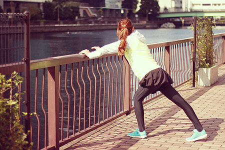 photo of women stretching beside body of water thumbnail