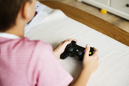 Photo of Person Holding Black Wireless Controller thumbnail